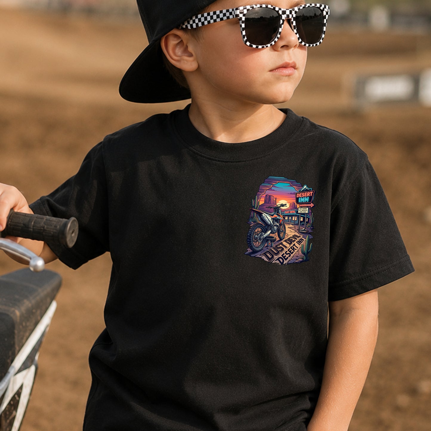 Kid wearing the Dust Devil Desert Inn dirt bike t-shirt