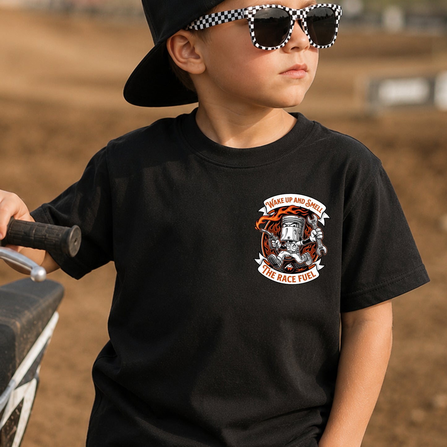 Kid wearing the Wake Up, Smell the Race Fuel dirt bike t-shirt