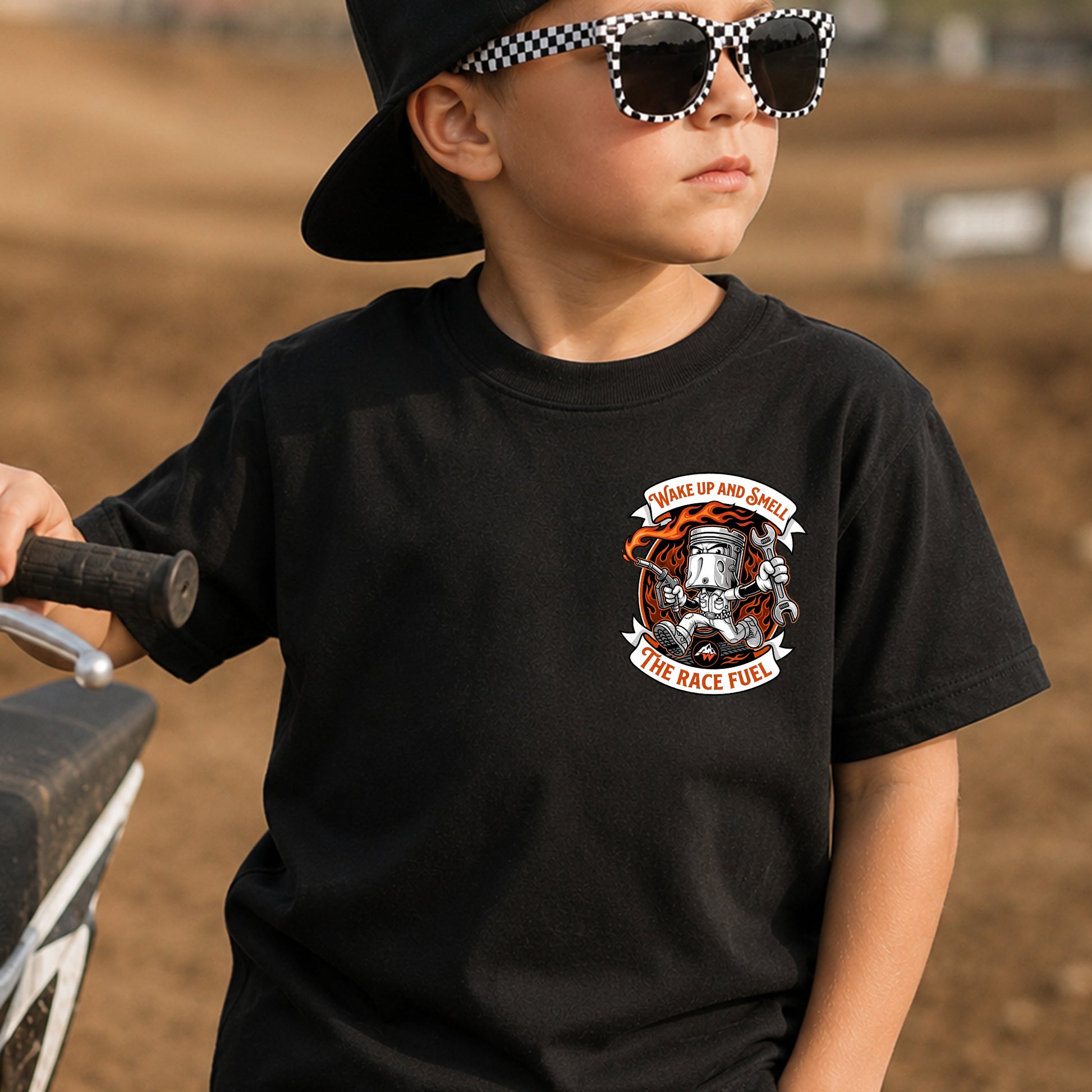 Kid wearing the Wake Up, Smell the Race Fuel dirt bike t-shirt